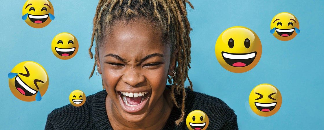 a girl laughing surrounded by a series of laughing emojis