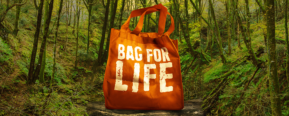 An orange tote bag with the words "Bag for Life" on it