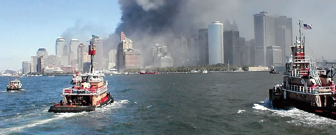 boats approaching Lower Manhattan while it&apos;s covered in smoke