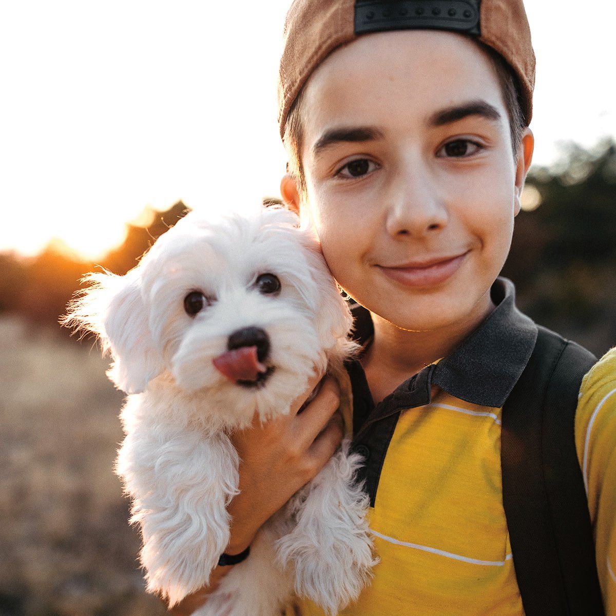 Image of a child holding a small white puppy