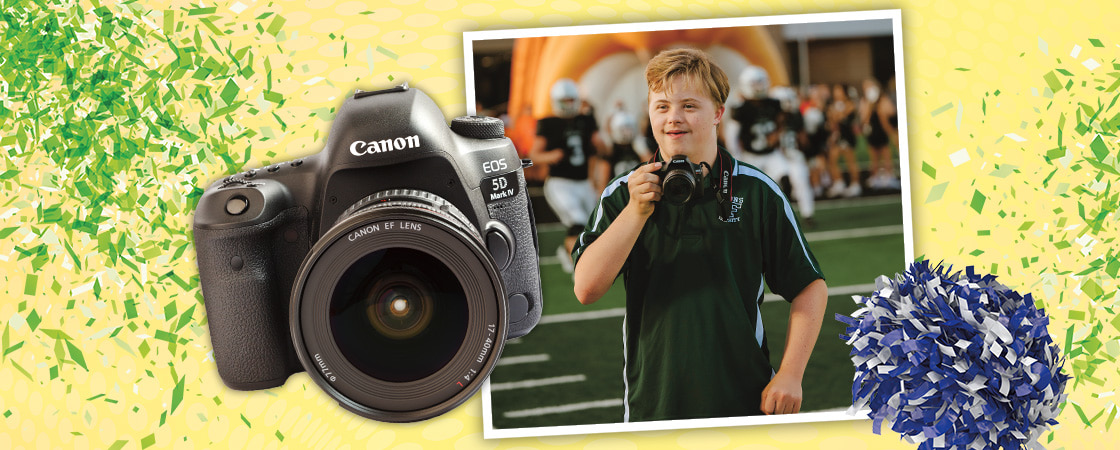 Image of teen, camera, and cheerleading pom-pom