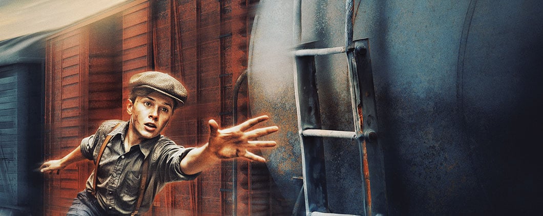 A boy in a cap reaches toward the camera with both arms outstretched